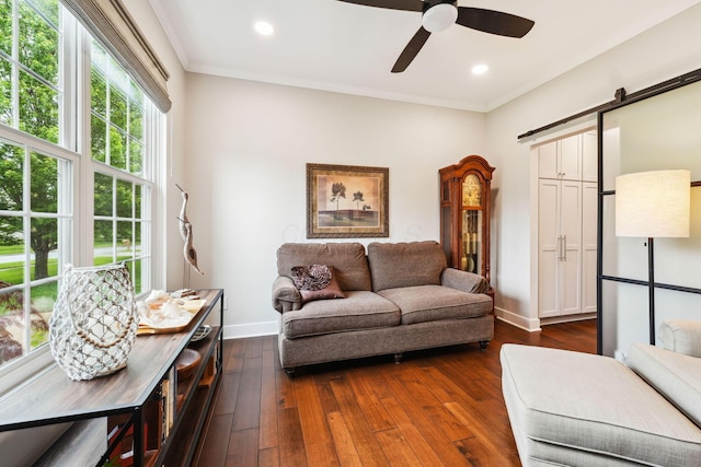 2407 Bryton Dr, Powell, OH 43065 - living room with a barn door, baseboards, crown molding, a ceiling fan, and dark wood-style floors