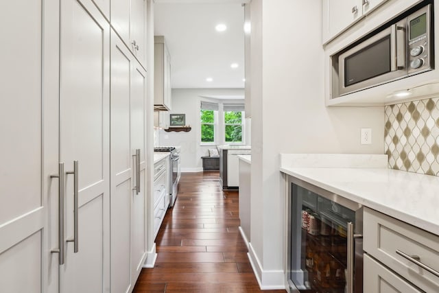 2407 Bryton Dr, Powell, OH 43065 - kitchen featuring stainless steel appliances, wine cooler, dark wood-type flooring, decorative backsplash, and recessed lighting