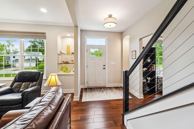 2407 Bryton Dr, Powell, OH 43065 - entrance foyer with dark wood-style flooring, arched walkways, stairway, baseboards, and recessed lighting
