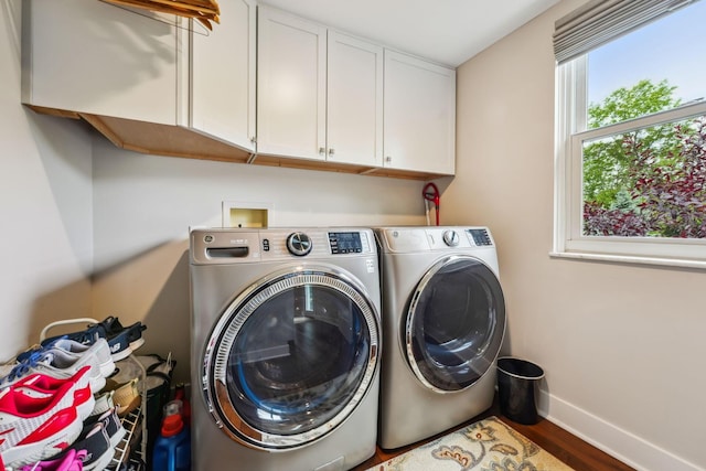 2407 Bryton Dr, Powell, OH 43065 - laundry room with cabinet space, washer and dryer, baseboards, and wood finished floors