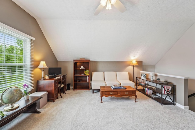 2407 Bryton Dr, Powell, OH 43065 - living room featuring carpet flooring, lofted ceiling, a ceiling fan, a desk, and a textured ceiling
