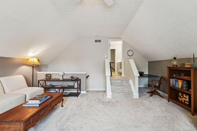 2407 Bryton Dr, Powell, OH 43065 - carpeted living room with a textured ceiling, vaulted ceiling, and baseboards