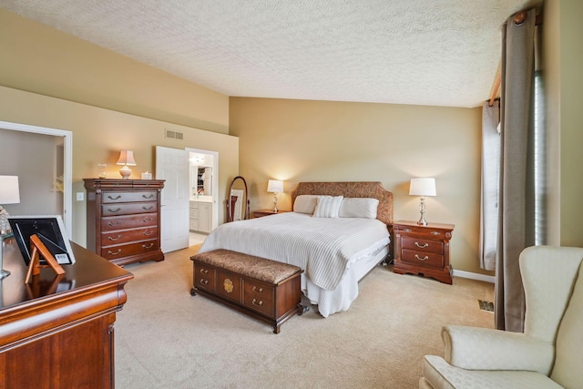 2407 Bryton Dr, Powell, OH 43065 - bedroom with light colored carpet, ensuite bath, lofted ceiling, and a textured ceiling