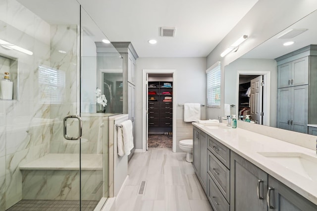 2407 Bryton Dr, Powell, OH 43065 - full bathroom featuring a shower stall, toilet, double vanity, a spacious closet, and recessed lighting