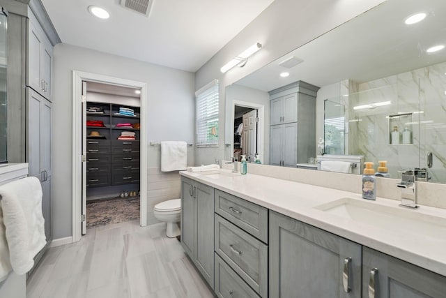 2407 Bryton Dr, Powell, OH 43065 - bathroom featuring a stall shower, toilet, a spacious closet, double vanity, and recessed lighting
