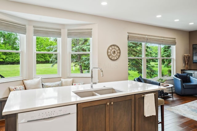 2407 Bryton Dr, Powell, OH 43065 - kitchen with white dishwasher, a sink, light countertops, recessed lighting, and dark wood finished floors
