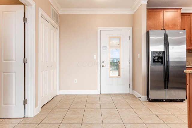 539 W 1st Ave Unit 308, Columbus, OH 43215 - kitchen with stainless steel fridge with ice dispenser, brown cabinets, crown molding, light tile patterned floors, and baseboards