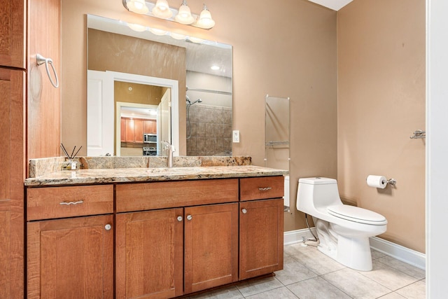 539 W 1st Ave Unit 308, Columbus, OH 43215 - bathroom featuring baseboards, tile patterned floors, vanity, toilet, and a tile shower