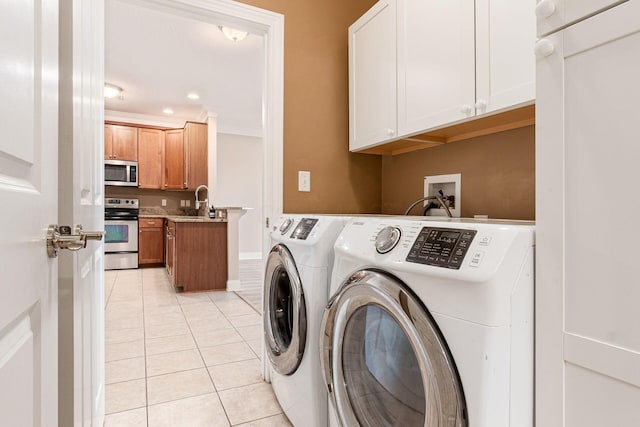 539 W 1st Ave Unit 308, Columbus, OH 43215 - laundry room with cabinet space, independent washer and dryer, and light tile patterned flooring