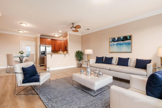 539 W 1st Ave Unit 308, Columbus, OH 43215 - living area with light wood finished floors, ceiling fan, crown molding, and baseboards