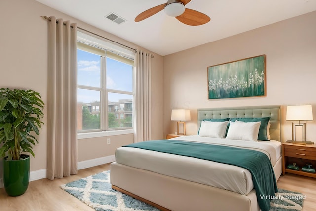 539 W 1st Ave Unit 308, Columbus, OH 43215 - bedroom with wood finished floors, baseboards, and ceiling fan