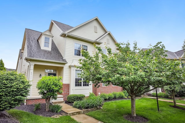 6711 Cooperstone Dr, Dublin, OH 43017 - view of front of home featuring a shingled roof, a front yard, and brick siding