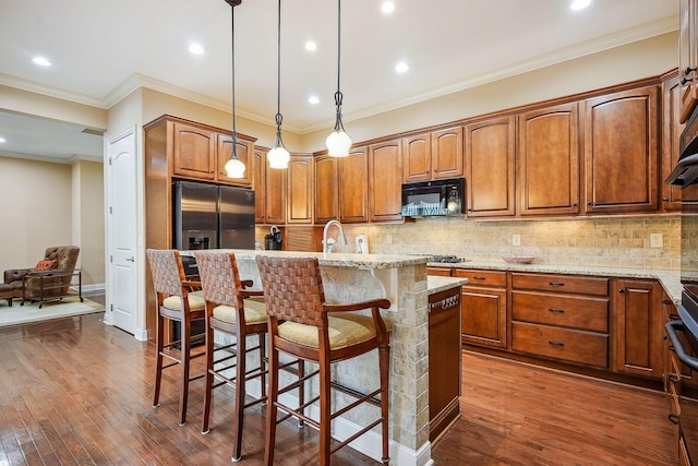 6711 Cooperstone Dr, Dublin, OH 43017 - kitchen featuring black microwave, light stone countertops, dark wood finished floors, a breakfast bar area, and recessed lighting