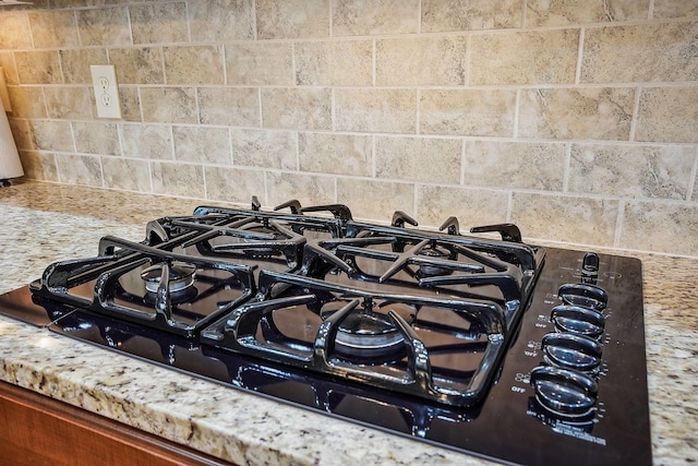6711 Cooperstone Dr, Dublin, OH 43017 - kitchen view of black gas cooktop, light countertops, and backsplash
