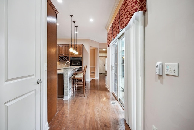 6711 Cooperstone Dr, Dublin, OH 43017 - corridor featuring plenty of natural light, light wood-style floors, baseboards, recessed lighting, and crown molding