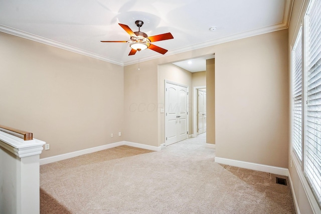 6711 Cooperstone Dr, Dublin, OH 43017 - empty room with light colored carpet, a ceiling fan, healthy amount of natural light, crown molding, and baseboards