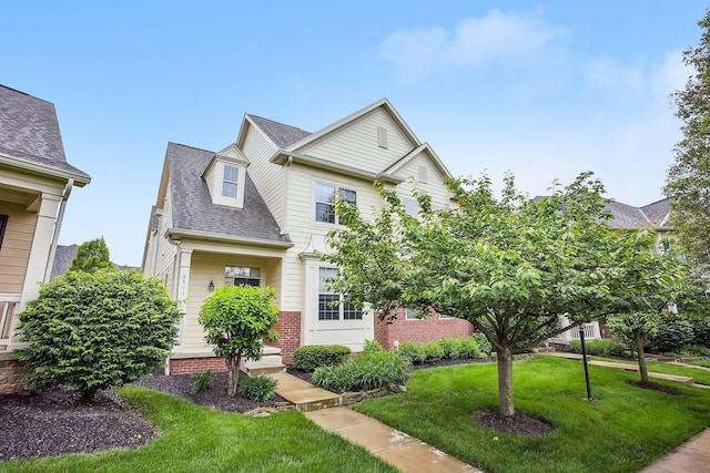 6711 Cooperstone Dr, Dublin, OH 43017 - view of front of home featuring a front lawn, a shingled roof, and brick siding