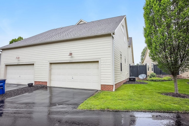 6711 Cooperstone Dr, Dublin, OH 43017 - view of property exterior with central air condition unit, a yard, a shingled roof, driveway, and a garage