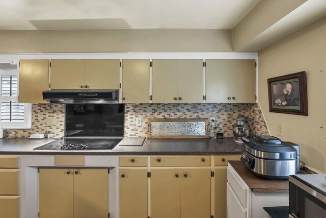 942 Mount Vernon Rd, Newark, OH 43055 - kitchen featuring under cabinet range hood, black electric stovetop, backsplash, and dark countertops