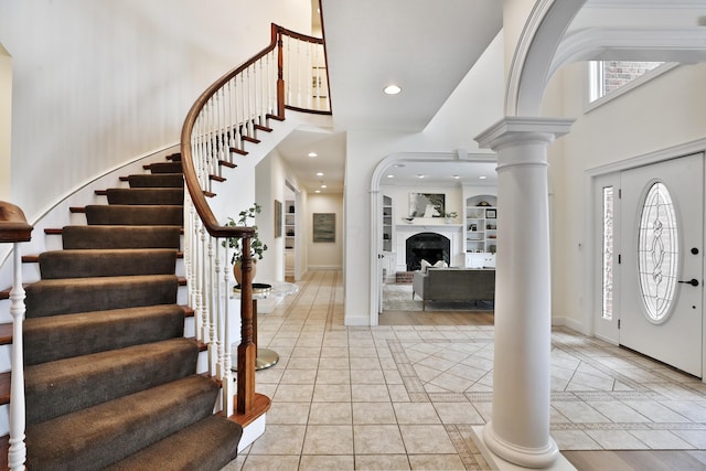 2300 Stonewall Cemetery Rd SW, Lancaster, OH 43130 - foyer with decorative columns, a towering ceiling, stairs, inlaid floor details, and baseboards