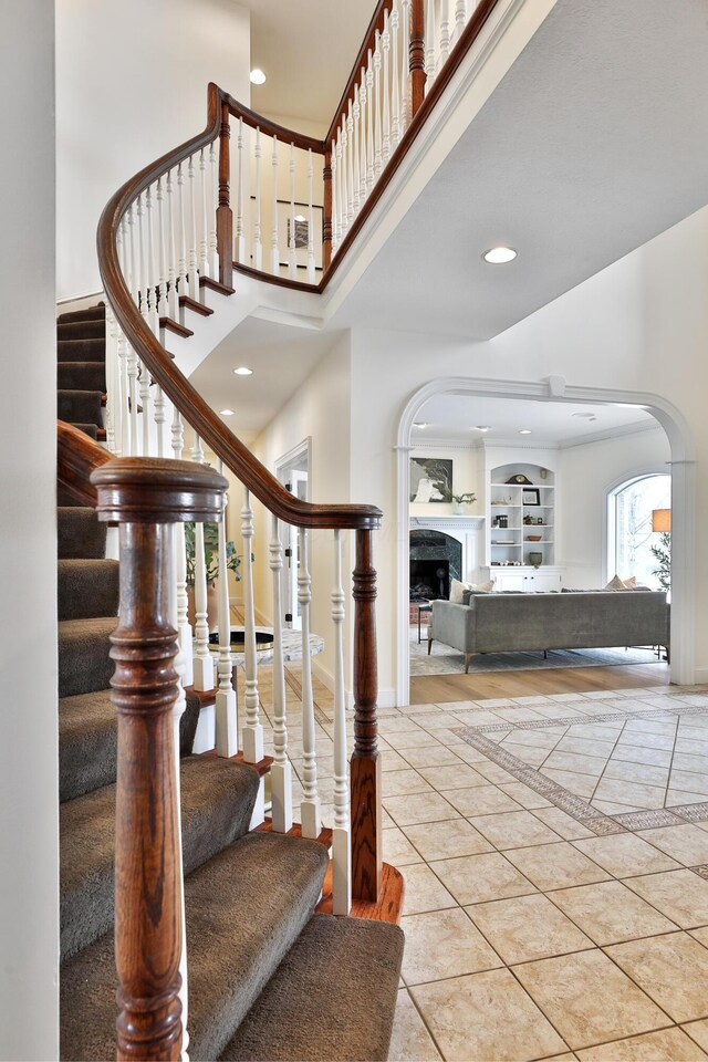 2300 Stonewall Cemetery Rd SW, Lancaster, OH 43130 - staircase featuring arched walkways, a towering ceiling, tile patterned floors, recessed lighting, and inlaid floor details