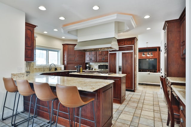 2300 Stonewall Cemetery Rd SW, Lancaster, OH 43130 - kitchen featuring a peninsula, backsplash, recessed lighting, a kitchen bar, and paneled fridge