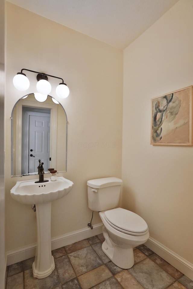 2300 Stonewall Cemetery Rd SW, Lancaster, OH 43130 - half bathroom featuring baseboards, toilet, and stone finish floors
