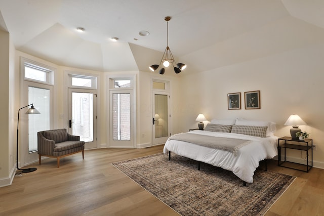 2300 Stonewall Cemetery Rd SW, Lancaster, OH 43130 - bedroom with light wood finished floors, a chandelier, baseboards, and vaulted ceiling