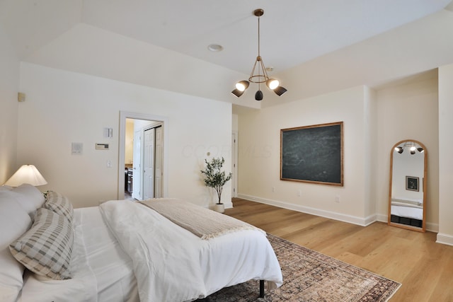 2300 Stonewall Cemetery Rd SW, Lancaster, OH 43130 - bedroom featuring a chandelier, light wood-style floors, and baseboards