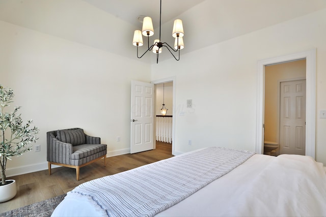2300 Stonewall Cemetery Rd SW, Lancaster, OH 43130 - bedroom with a chandelier, wood finished floors, baseboards, and ensuite bath