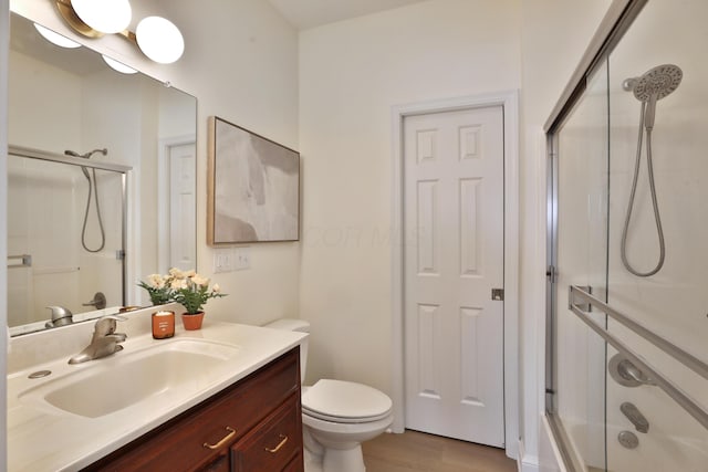 2300 Stonewall Cemetery Rd SW, Lancaster, OH 43130 - full bath with vanity, toilet, combined bath / shower with glass door, and wood finished floors