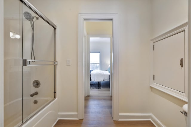 2300 Stonewall Cemetery Rd SW, Lancaster, OH 43130 - ensuite bathroom with wood finished floors, baseboards, and shower / bath combination with glass door