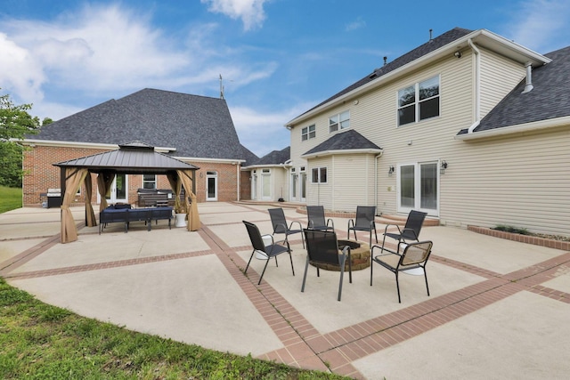 2300 Stonewall Cemetery Rd SW, Lancaster, OH 43130 - rear view of house with a patio area, a gazebo, roof with shingles, and brick siding