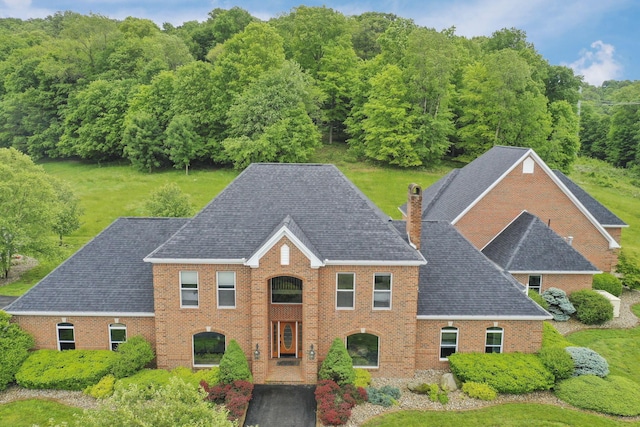 2300 Stonewall Cemetery Rd SW, Lancaster, OH 43130 - view of front of home featuring brick siding, a chimney, a shingled roof, and a view of trees