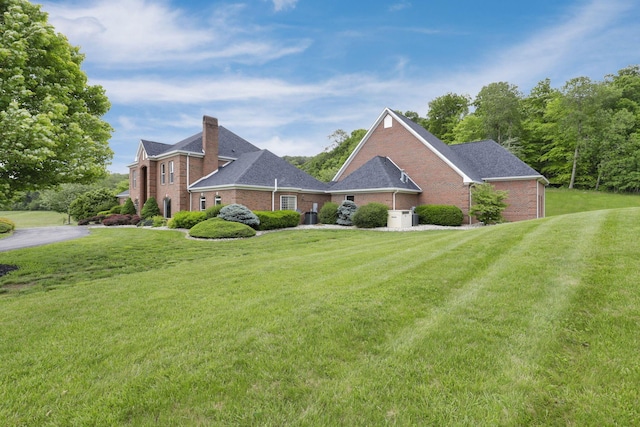 2300 Stonewall Cemetery Rd SW, Lancaster, OH 43130 - view of front of home featuring brick siding, a front yard, and a chimney