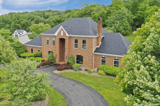 2300 Stonewall Cemetery Rd SW, Lancaster, OH 43130 - view of front of home featuring a chimney, brick siding, roof with shingles, and asphalt driveway