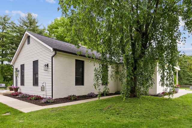 5210 Chevy Chase Ct, Columbus, OH 43220 - view of home's exterior featuring a lawn, brick siding, and a shingled roof