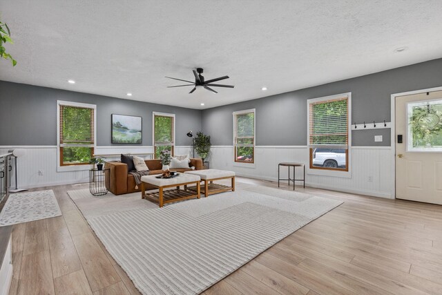 5210 Chevy Chase Ct, Columbus, OH 43220 - living area featuring a wainscoted wall, a textured ceiling, a ceiling fan, light wood finished floors, and recessed lighting