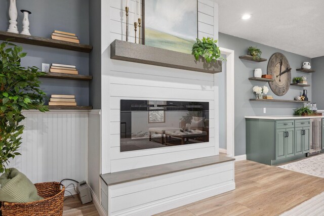 5210 Chevy Chase Ct, Columbus, OH 43220 - living room featuring a glass covered fireplace, light wood-type flooring, recessed lighting, and baseboards