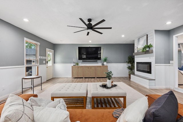 5210 Chevy Chase Ct, Columbus, OH 43220 - living room featuring wainscoting, ceiling fan, a fireplace, light wood-style floors, and recessed lighting