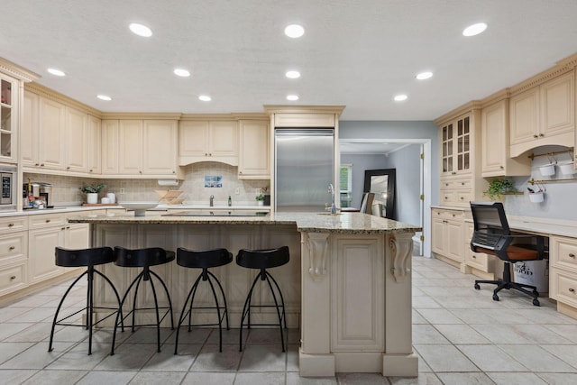 5210 Chevy Chase Ct, Columbus, OH 43220 - kitchen featuring built in appliances, recessed lighting, decorative backsplash, and cream cabinetry