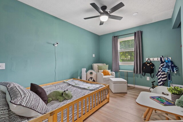 5210 Chevy Chase Ct, Columbus, OH 43220 - bedroom featuring wood finished floors, a textured ceiling, a ceiling fan, and baseboards