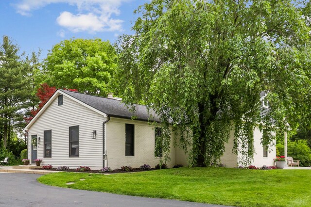 5210 Chevy Chase Ct, Columbus, OH 43220 - view of front facade with a front lawn, brick siding, a shingled roof, and a chimney