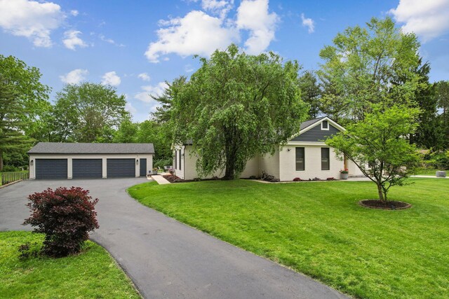 5210 Chevy Chase Ct, Columbus, OH 43220 - view of front of house with driveway, a front yard, and an outdoor structure