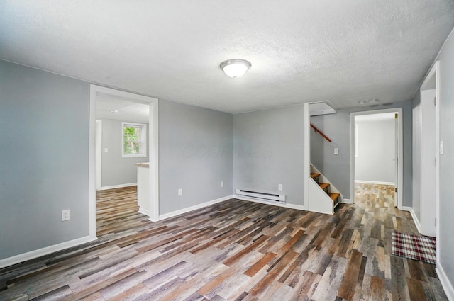 8301 Bennington Chapel Rd, Centerburg, OH 43011 - basement with a baseboard radiator, wood finished floors, stairs, a textured ceiling, and baseboards