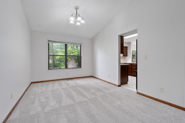 2321 Worthingwoods Blvd, Powell, OH 43065 - unfurnished room featuring vaulted ceiling, light colored carpet, a chandelier, and baseboards