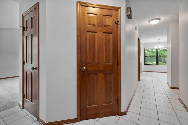 2321 Worthingwoods Blvd, Powell, OH 43065 - corridor with light tile patterned floors, baseboards, and a chandelier