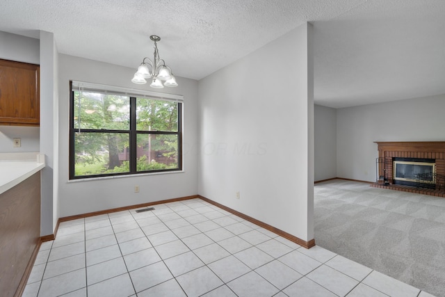 2321 Worthingwoods Blvd, Powell, OH 43065 - unfurnished dining area featuring a chandelier, a textured ceiling, a fireplace, and baseboards