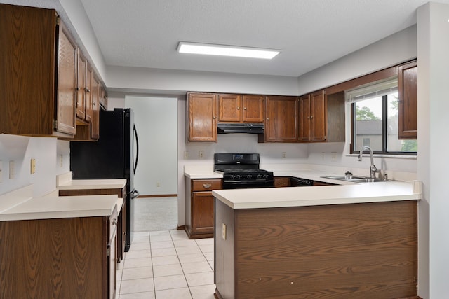 2321 Worthingwoods Blvd, Powell, OH 43065 - kitchen featuring black appliances, under cabinet range hood, a sink, a peninsula, and light countertops