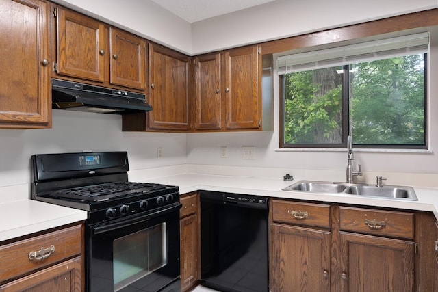 2321 Worthingwoods Blvd, Powell, OH 43065 - kitchen featuring black appliances, under cabinet range hood, a sink, and light countertops